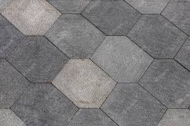 Close-up of gray hexagonal paving tiles arranged in a geometric pattern.